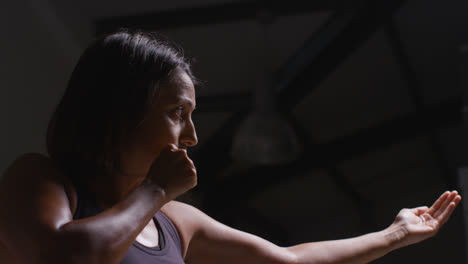 Profile-Shot-Of-Mature-Woman-Wearing-Gym-Fitness-Clothing-Exercising-Beckoning-Sparring-Partner